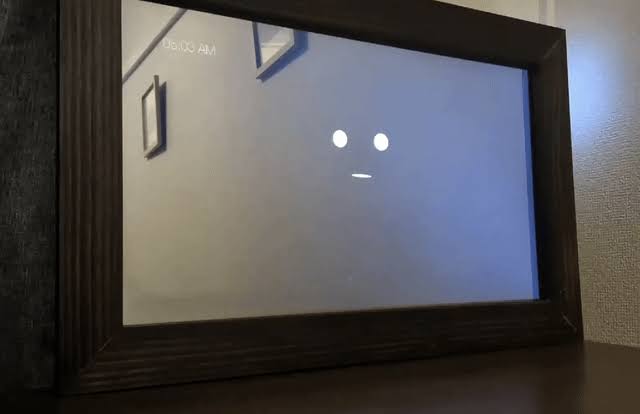 AI smart mirror prototype with a minimalist face display inside a dark wooden mirror frame